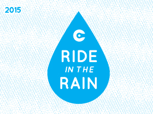 a picture of a white rectangle with a blue raindrop saying 2015 Ride in the Rain