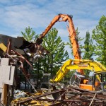 A second excavator takes the refuse and neatly stacks it into recyclable and non-recyclable piles.