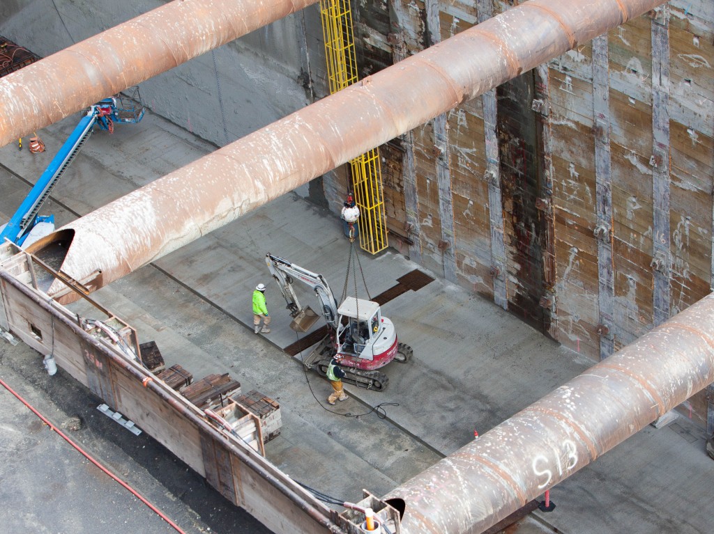 The excavator deposited into the station pit.