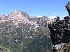 Chris on ledge, with Fortress Mtn in background.